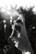 Hand spraying Mullum Minerals magnesium oil for relaxation, muscle recovery and daily wellness ritual
